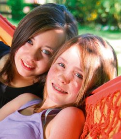 Whitney leaning against a railing on a downtown street